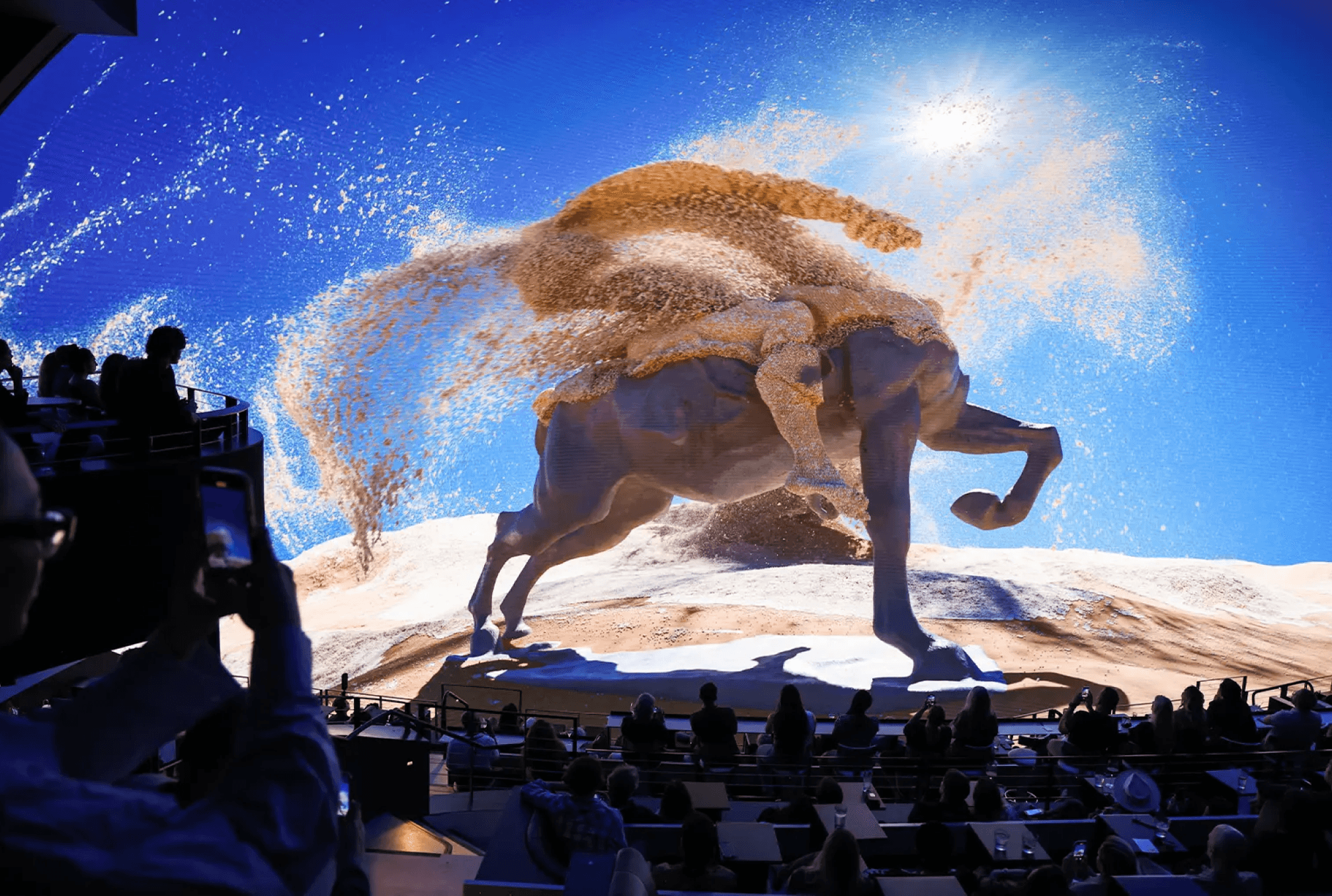 A statue of a horse rider turns to sand, which blows away in the wind